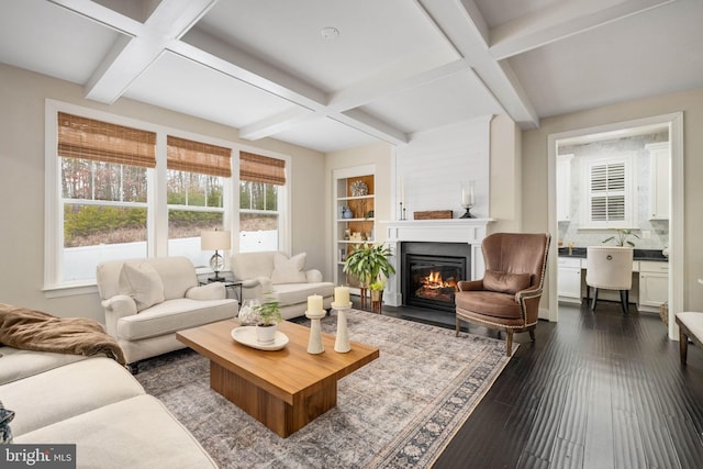 living room with coffered ceiling, dark wood-type flooring, and beamed ceiling