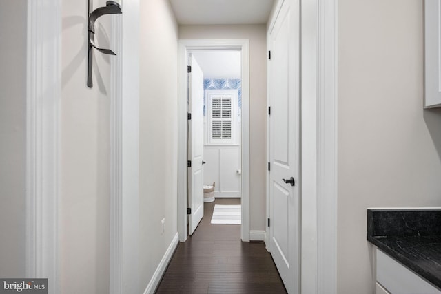 hallway with dark hardwood / wood-style floors