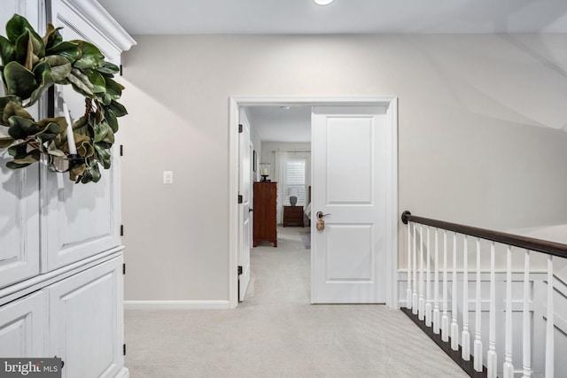 hallway with light colored carpet