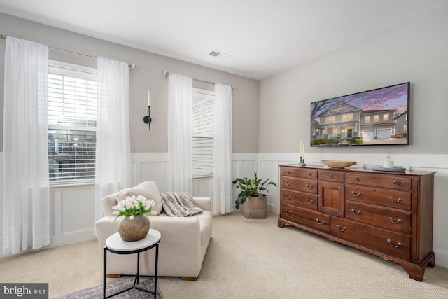 sitting room featuring light carpet