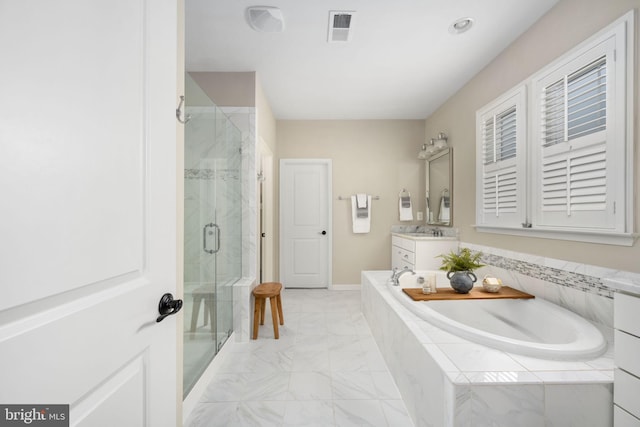 bathroom featuring vanity and independent shower and bath