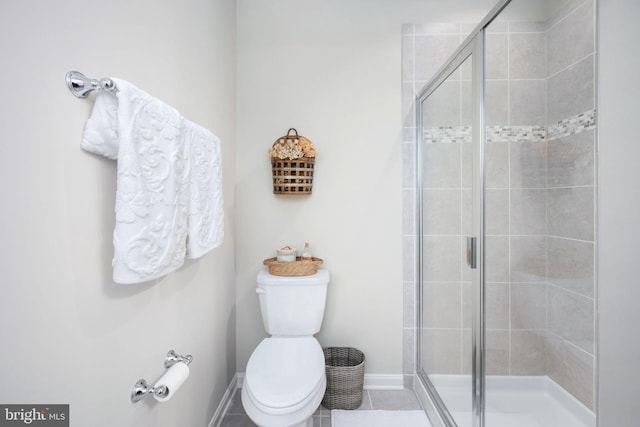 bathroom with an enclosed shower and toilet