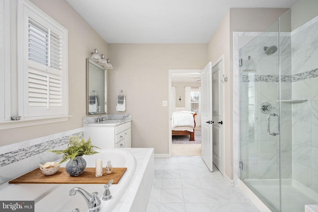 bathroom featuring vanity and shower with separate bathtub