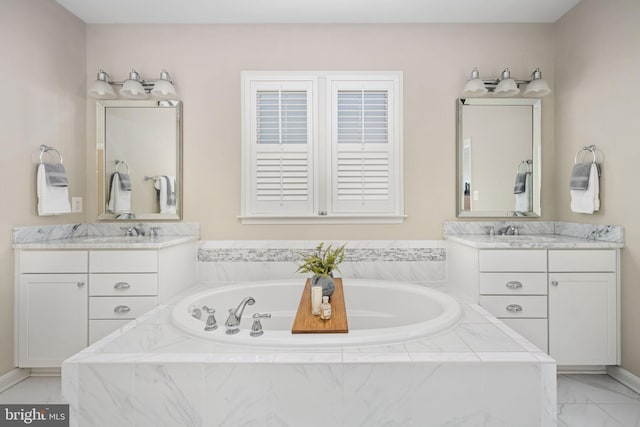 bathroom featuring vanity and tiled bath