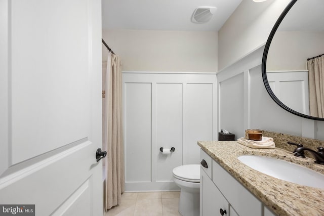 bathroom featuring tile patterned floors, toilet, and vanity