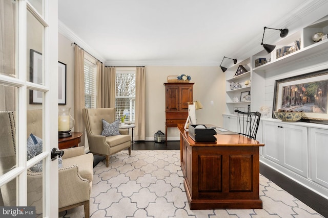 office area with built in shelves, light hardwood / wood-style flooring, and ornamental molding