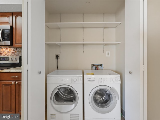 laundry area with washing machine and clothes dryer