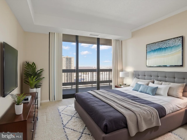 bedroom featuring crown molding, a wall of windows, access to exterior, and light carpet