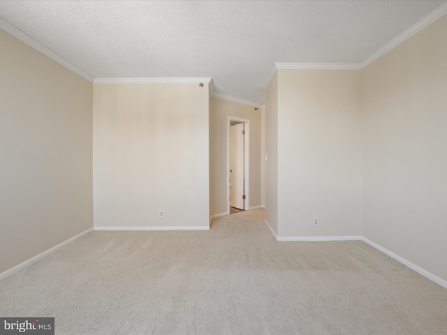 empty room featuring ornamental molding, light carpet, and a textured ceiling