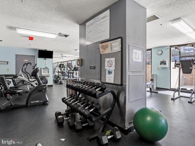 exercise room featuring a textured ceiling