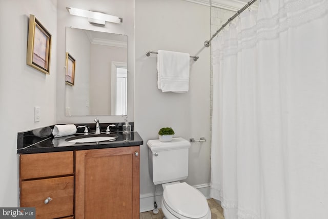 bathroom featuring vanity, toilet, and crown molding