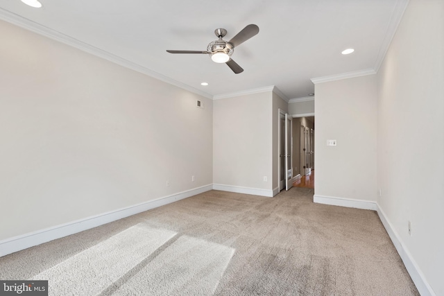 carpeted spare room with crown molding and ceiling fan