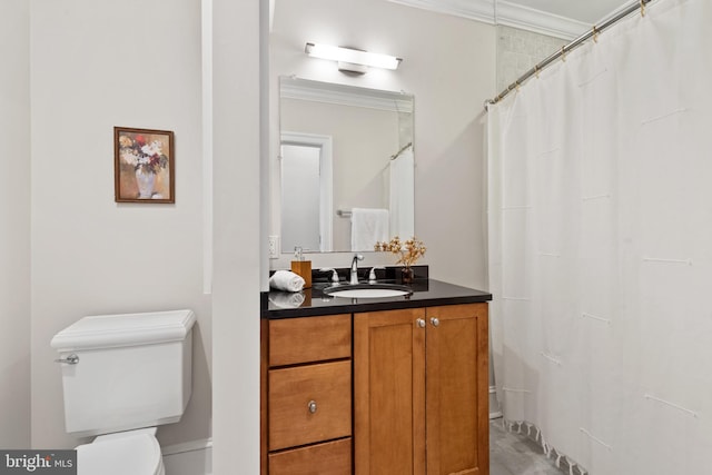 bathroom with vanity, toilet, and ornamental molding