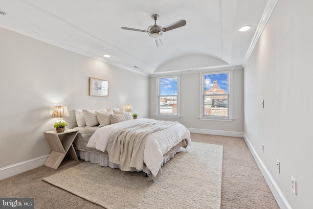 carpeted bedroom with crown molding, vaulted ceiling, and ceiling fan