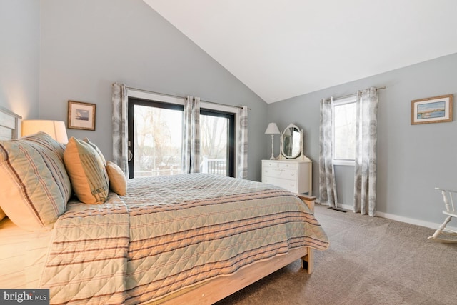 carpeted bedroom featuring lofted ceiling