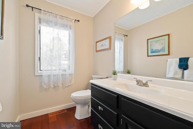 bathroom featuring vanity, toilet, and wood-type flooring