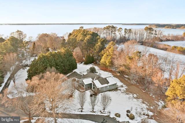 snowy aerial view with a water view