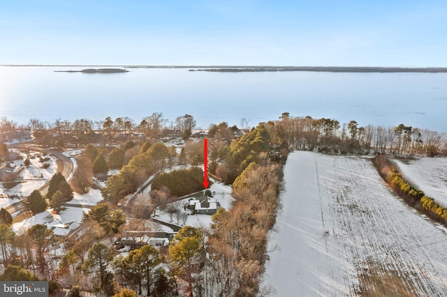 snowy aerial view featuring a water view