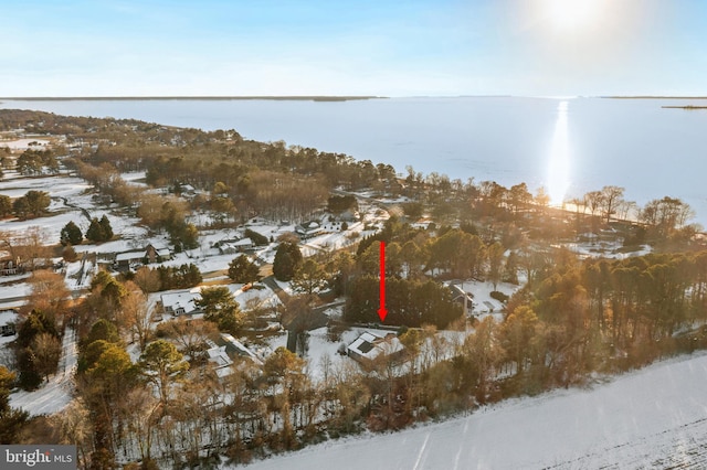 snowy aerial view with a water view