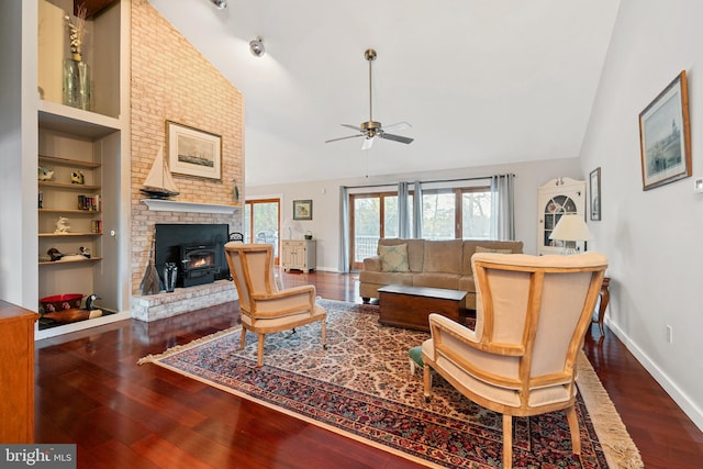 living room with built in features, ceiling fan, dark hardwood / wood-style floors, and lofted ceiling