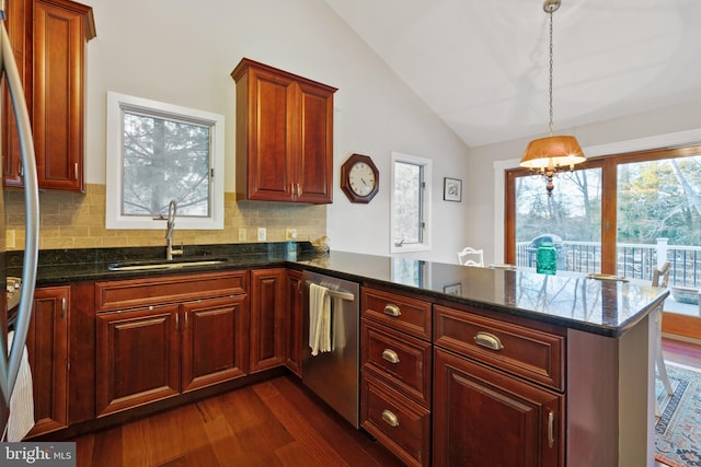 kitchen with sink, tasteful backsplash, kitchen peninsula, and appliances with stainless steel finishes