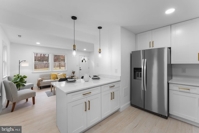 kitchen featuring white cabinets, stainless steel fridge with ice dispenser, light hardwood / wood-style flooring, and pendant lighting