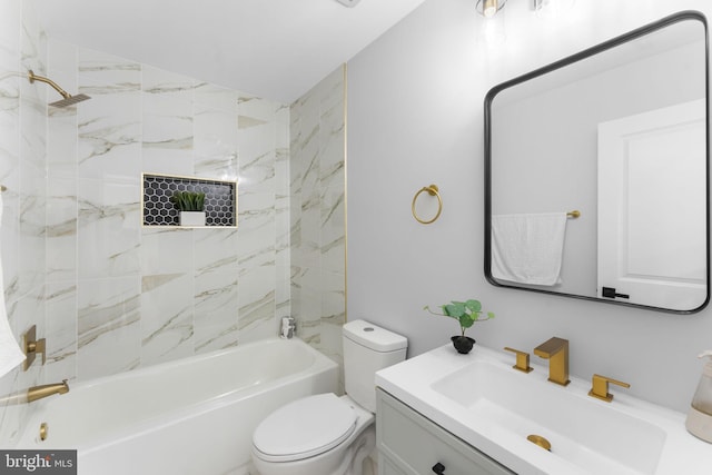 full bathroom featuring toilet, tiled shower / bath combo, and vanity