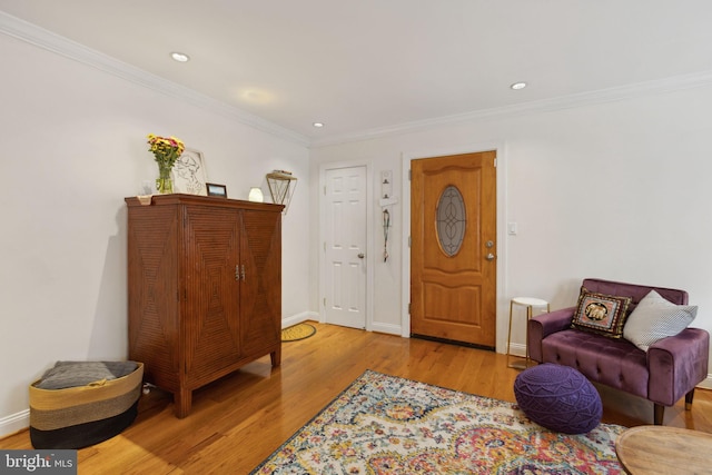 sitting room with light hardwood / wood-style flooring and crown molding