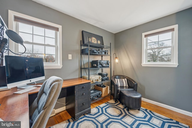 office area with baseboards and wood finished floors