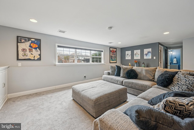 living area featuring light colored carpet, visible vents, baseboards, and recessed lighting