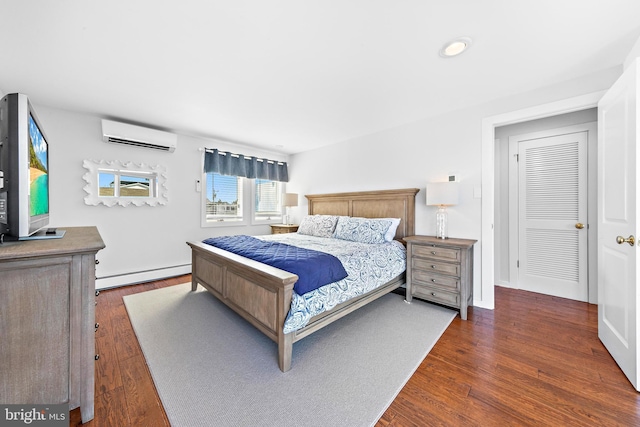 bedroom featuring dark hardwood / wood-style flooring, a wall unit AC, and a baseboard radiator