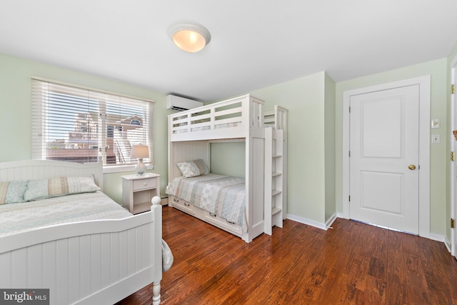 bedroom featuring a wall mounted AC and dark hardwood / wood-style floors