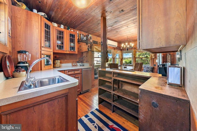 kitchen with a wall mounted AC, a notable chandelier, sink, light wood-type flooring, and wooden ceiling