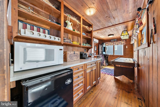 kitchen featuring beverage cooler, wood ceiling, wooden walls, a wall mounted AC, and light hardwood / wood-style flooring