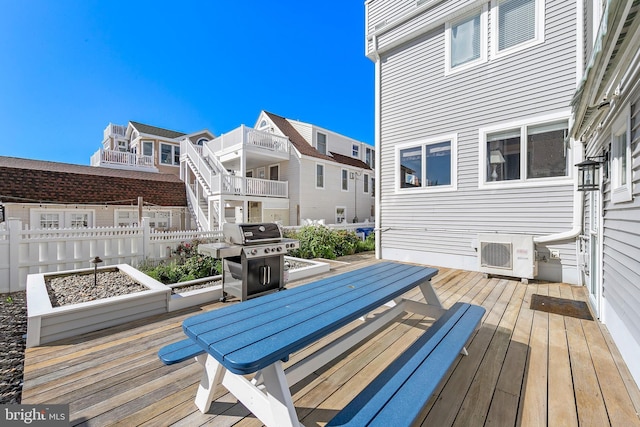 wooden deck featuring a grill