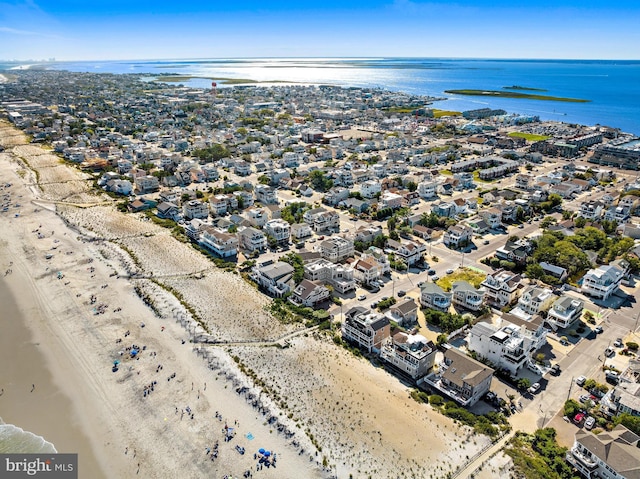 drone / aerial view featuring a water view and a beach view