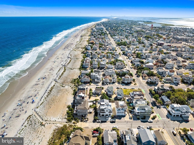 drone / aerial view with a water view and a view of the beach