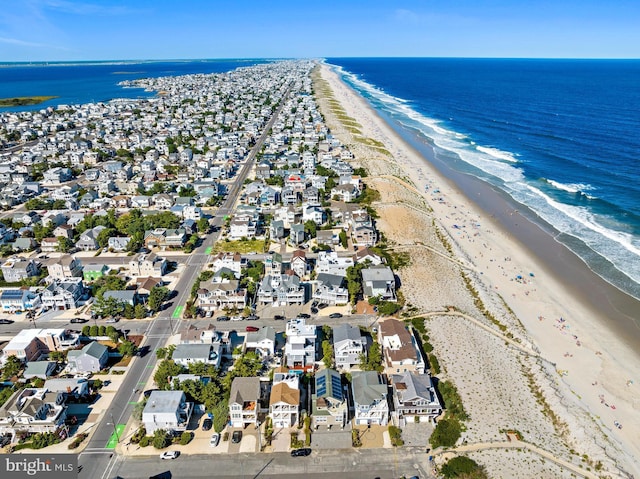 drone / aerial view with a water view and a view of the beach