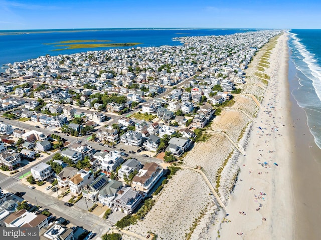 drone / aerial view with a water view and a view of the beach