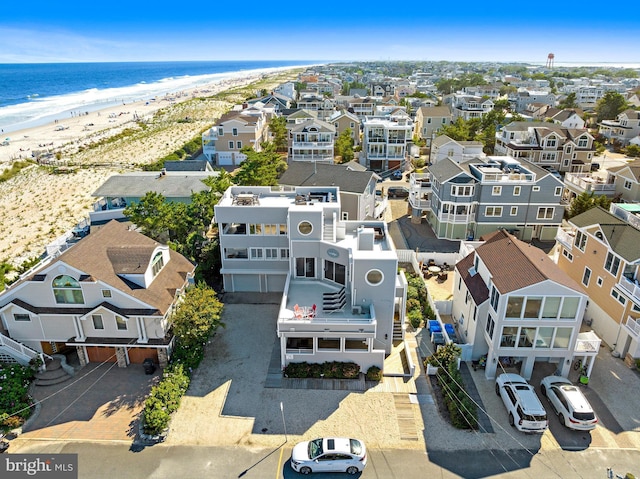 drone / aerial view with a beach view and a water view