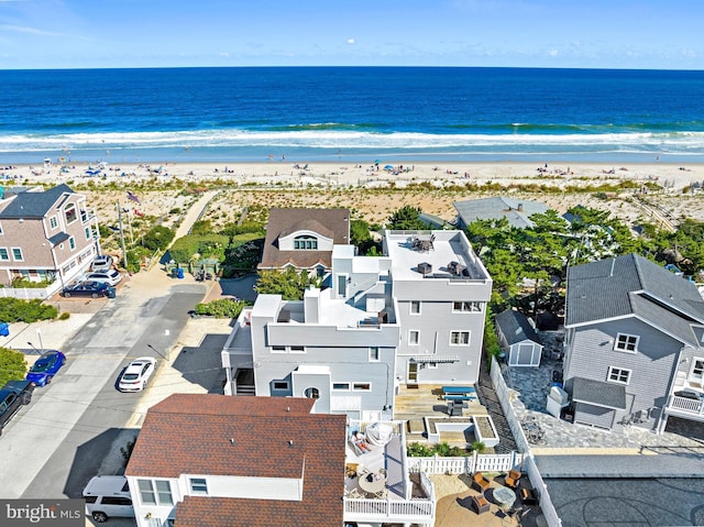 bird's eye view featuring a view of the beach and a water view