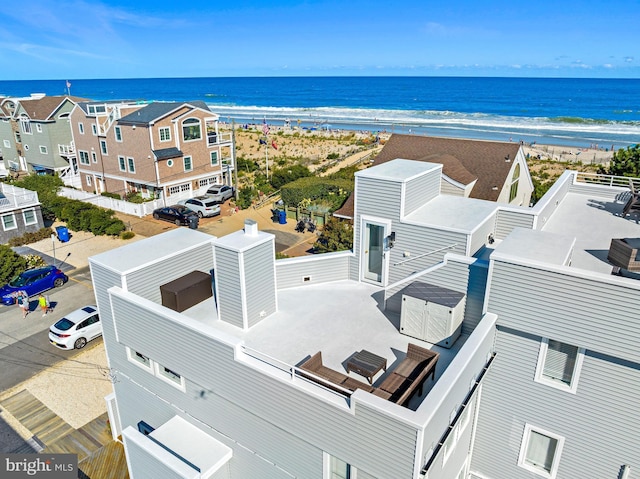 birds eye view of property featuring a beach view and a water view