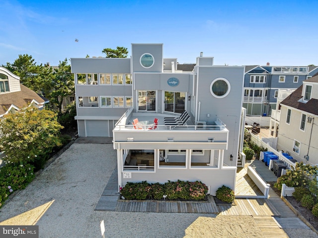 view of front of home featuring a garage and a balcony