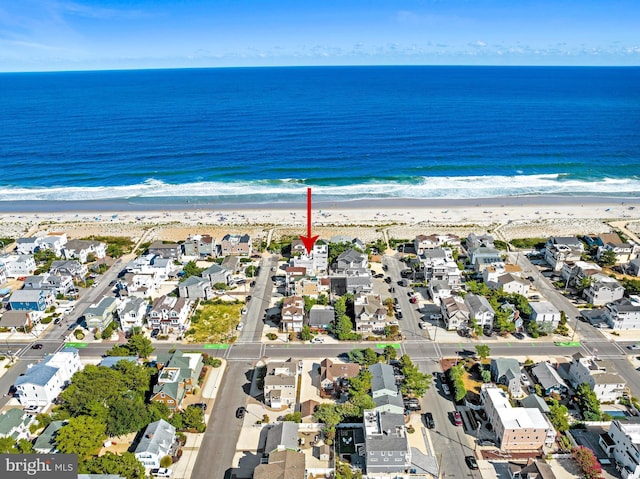 bird's eye view featuring a beach view and a water view