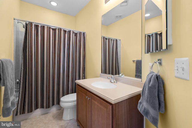 bathroom with toilet, vanity, tile patterned flooring, and curtained shower