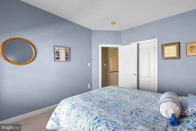 bedroom featuring a closet and light colored carpet