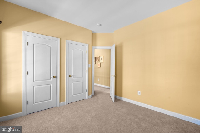 unfurnished bedroom with light carpet