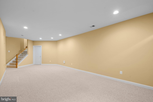 spare room featuring light colored carpet