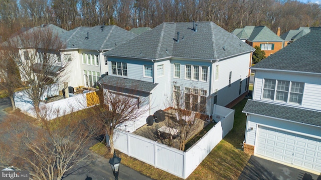 rear view of property featuring a garage