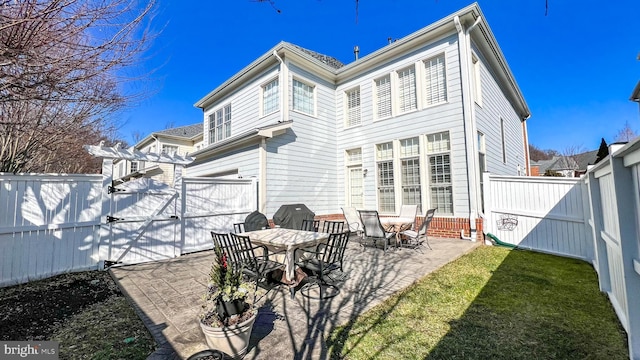 back of property with a patio and a lawn